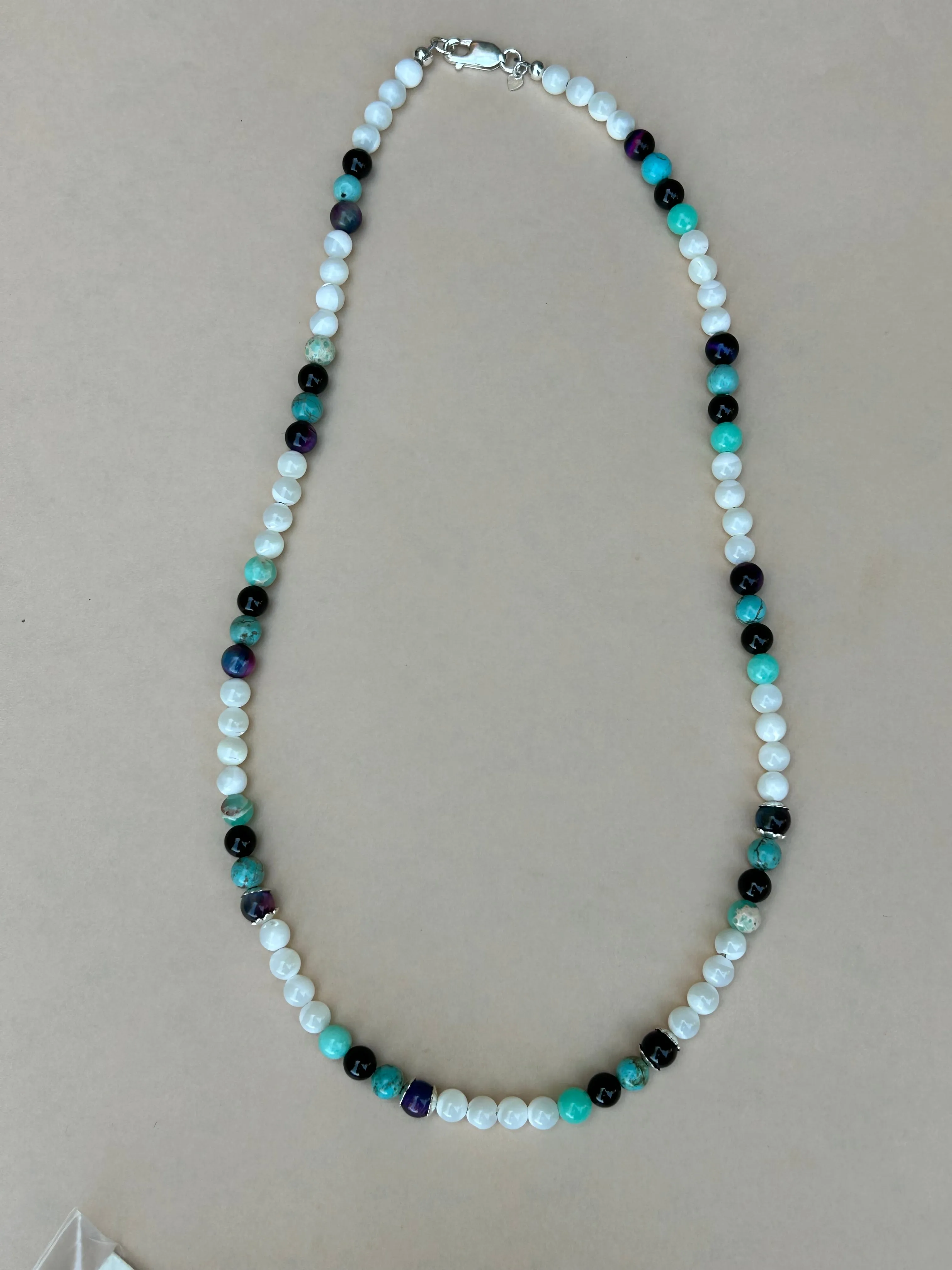 Genuine Mother of Pearl, black onyx, purple tiger eye, and sea sediment Jasper stones in a 20” necklace.  AS704